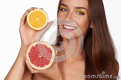 Beautiful brunette woman with citrus on a white background, healthy food, tasty food, organic diet, smile healthy Stock Photo