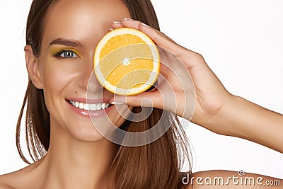 Beautiful brunette woman with citrus on a white background, healthy food, tasty food, organic diet, smile healthy Stock Photo