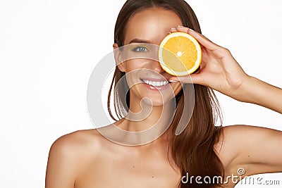 Beautiful brunette woman with citrus on a white background, healthy food, tasty food, organic diet, smile healthy Stock Photo