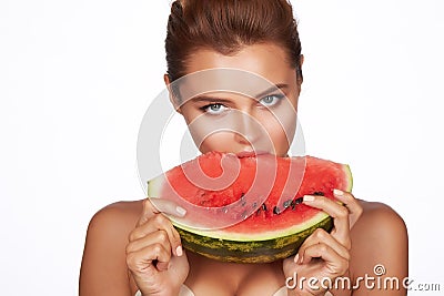 Beautiful brunette woman eating watermelon on a white background, healthy food, tasty food, organic Stock Photo