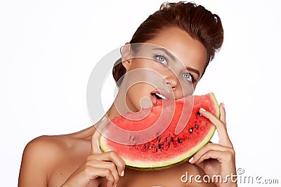 Beautiful brunette woman eating watermelon on a white background, healthy food, tasty food, organic Stock Photo