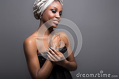 Beautiful girl black woman with make-up and a scarf on his head in the studio Stock Photo