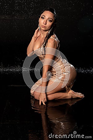 beautiful sexy model in aqua photostudio, sexy wet girl on black background, attractive girl sitting in water, aqua photography Stock Photo
