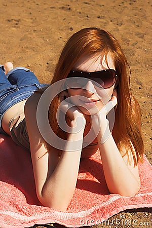 Beautiful red womani laying on sea beach Stock Photo