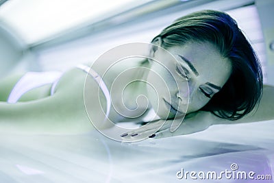 Beautiful woman tanning in solarium Stock Photo