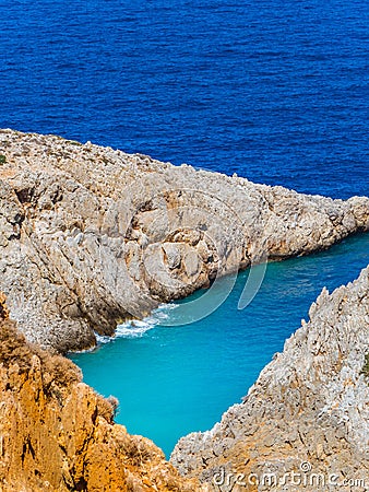 Beautiful shades of blue sea and orange cliffs - Greece Stock Photo