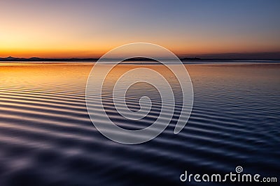 Beautiful and sharp water ripples on Trasimeno lake Umbria, Italy at dusk Stock Photo