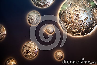 Beautiful shiny decorative planets on blue wall background Stock Photo