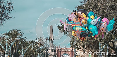 Beautiful shot of different cartoon balloons sold in the park Stock Photo