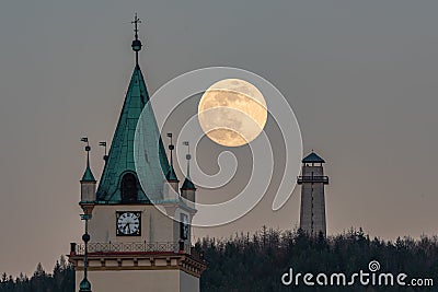 Beautiful shot of a full supermoon behind the Tisnov church Stock Photo