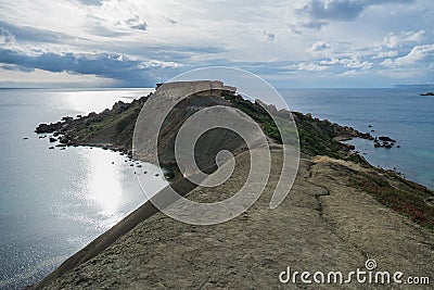 Beautiful shot of the Gnejna bay beach in Malta on a gloomy day Stock Photo