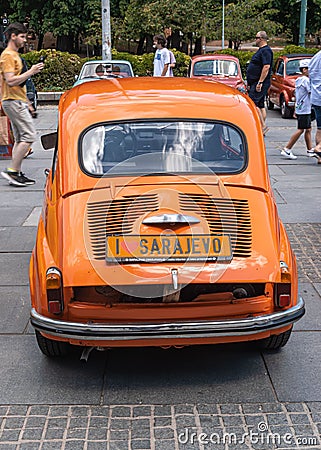 Beautiful shot of an orange retro car from behind in Fiat-Fico Fest 2022 in Sarajevo Editorial Stock Photo