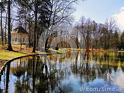 Beautiful shot of the pond with trees and arbor on its shore in Jelenia GÃ³ra, Poland. Stock Photo