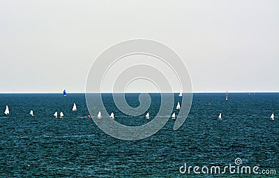 Beautiful shot of sailboats floating on the sea under the cloudy sky Stock Photo