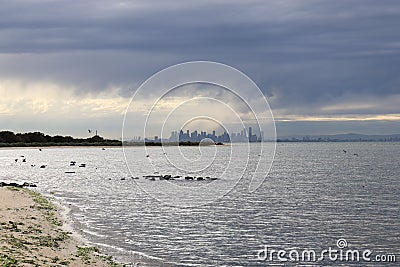 Beautiful shot of a seashore with a view of Melbourne in the distance Stock Photo