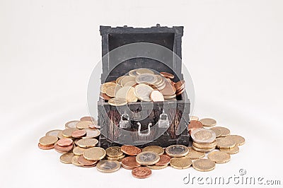 Beautiful shot of a small treasure box full of coins with a white color in the background Stock Photo