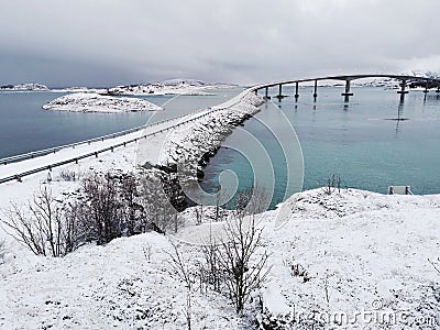 Beautiful shot of the snowy Sommaroy Bridge connecting the islands of Kvaloya and Sommaroy Stock Photo