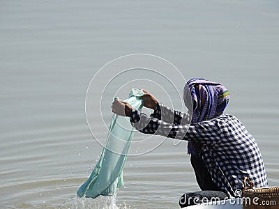 Beautiful shot of some women doing their laundry in the local river in Myanmar Editorial Stock Photo