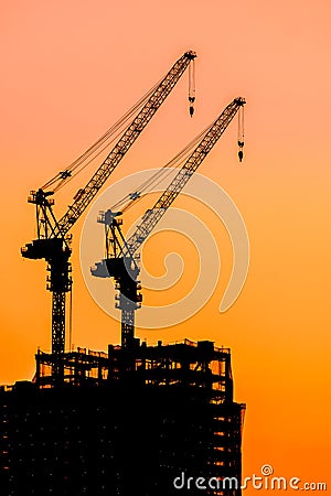 Beautiful Silhouette crane under construction building Stock Photo
