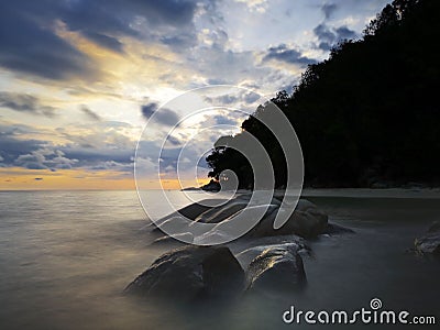 Sunset view with silky smooth water reflection on the sea shore landscape with beautiful sunset view. Stock Photo