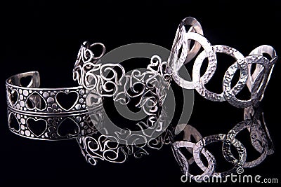 Beautiful silver bracelets on black background Stock Photo