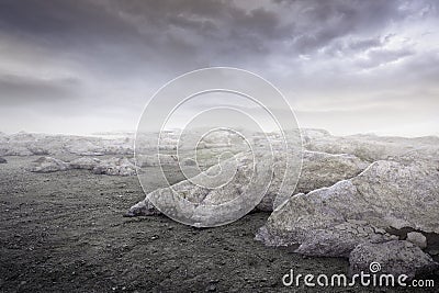 Beautiful simple dark gravel rocks background with mist and clouds Stock Photo