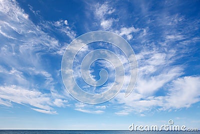 Beautiful sky over the sea with cirrus and small cumulus clouds Stock Photo