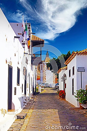 Beautiful sleepy canarian calm village, cobblestone alley, bright white houses, blue summer sky - La Oliva, North Fuerteventura Editorial Stock Photo