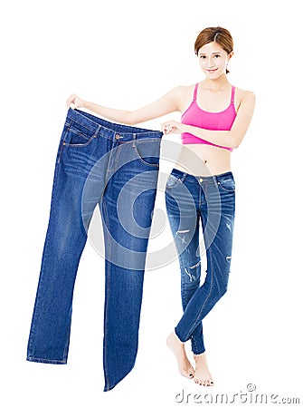 beautiful slim young woman with big jeans Stock Photo