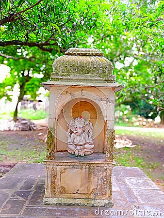 A beautiful small marble temple where is a deity in the garden, India Editorial Stock Photo