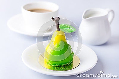 Beautiful Small Mousse Cake in Shape of Pear Tasty Modern Dessert Pastry White Blue Background Cup of Coffee Stock Photo