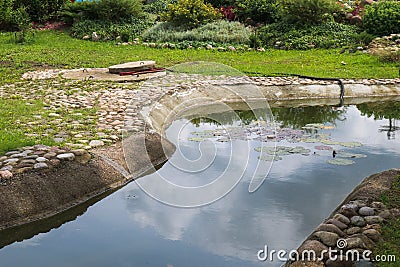 Beautiful small small pond stone natural homemade in nature. Landscaping with artificial pond Stock Photo