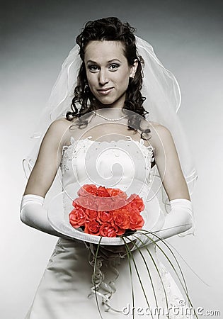 Beautiful smiley bride with bunch of flowers Stock Photo