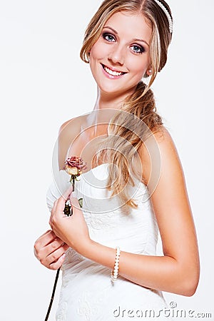 Beautiful smiley bride with rose Stock Photo