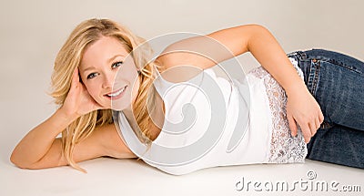 Beautiful Smiling Blonde Lying Down and Relaxing Stock Photo