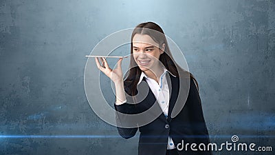 Beautiful smiling businesswoman is holding the tray and looking at something Stock Photo