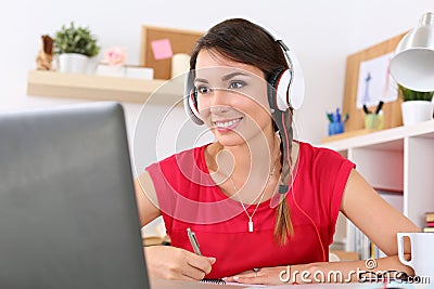 Beautiful smiling female student using online education service Stock Photo