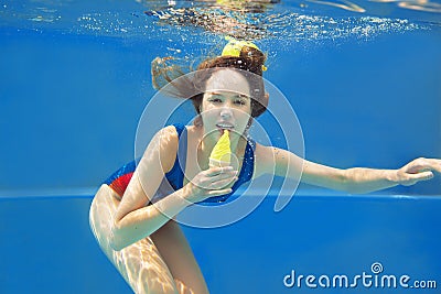 Beautiful smiling girl eating yellow ice cream underwater Stock Photo