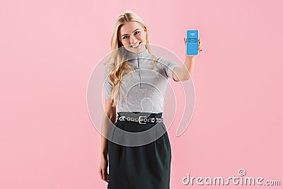 Beautiful smiling girl showing smartphone with skype app on screen, isolated Editorial Stock Photo