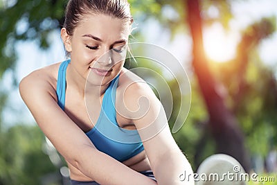 Beautiful smiling girl stretching before fitness Stock Photo