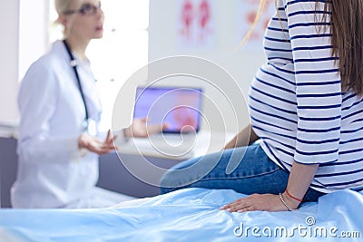 Beautiful smiling pregnant woman with the doctor at hospital Stock Photo