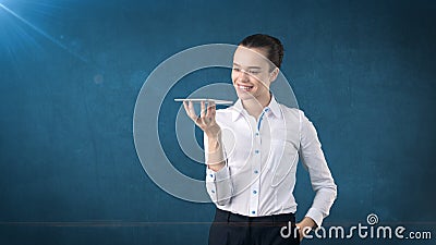 Beautiful smiling woman holding a tray and looking at you. Isolated studio background with copyspace. Business concept. Stock Photo