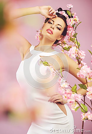 Beautiful smiling woman with spring flowers Stock Photo