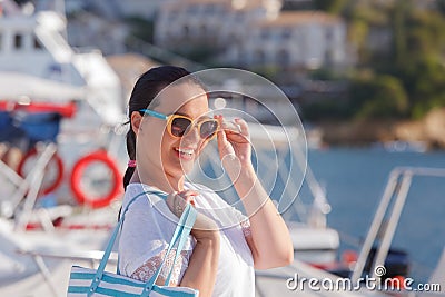 Beautiful smiling woman walking near the yacht marine Stock Photo