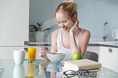 beautiful smiling young woman eating muesli for breakfast Stock Photo