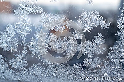 Beautiful snow patterns, water ornaments on transparent glass.Christmas snowflakes. Stock Photo