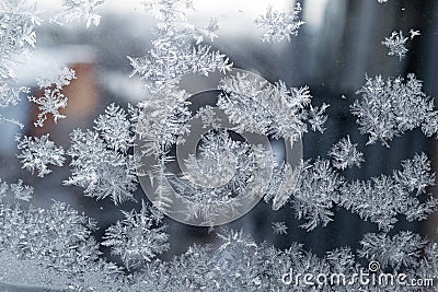 Beautiful snow patterns, water ornaments on transparent glass.Christmas snowflakes. Stock Photo