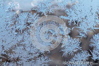 Beautiful snow patterns, water ornaments on transparent glass.Christmas snowflakes. Stock Photo