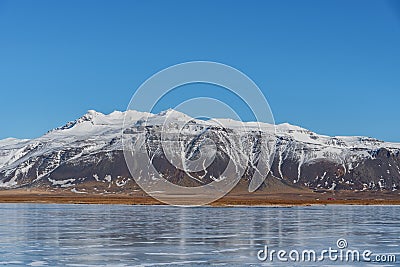 Beautiful snowcapped mountains seen from the highway in Iceland Stock Photo