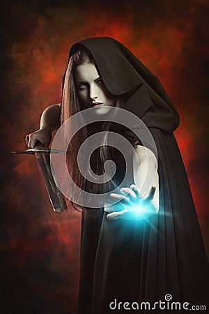 Beautiful sorceress in fighting position with sword Stock Photo